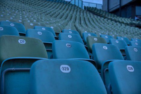 Das Foto zeigt eine Stuhlreihe in einem Stadion. 