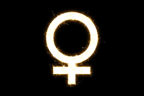 Das Foto zum Weltfrauentag zeigt auf schwarzem Hintergrund das Symbol für Weiblichkeit